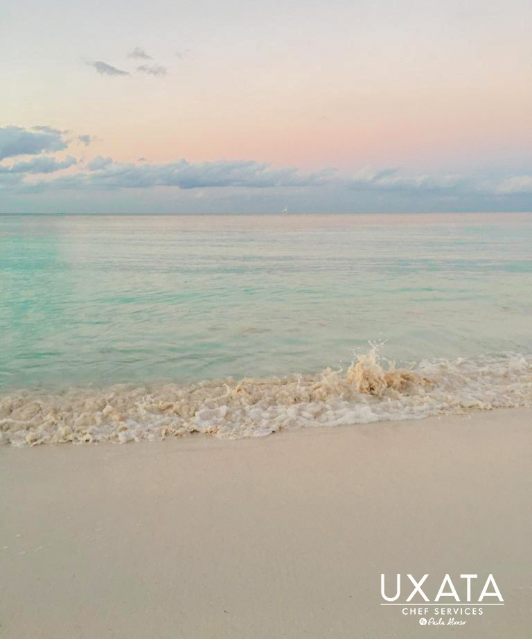 Sand and crystal clear waters on the coast of Punta Maroma, Riviera Maya, Mexico.