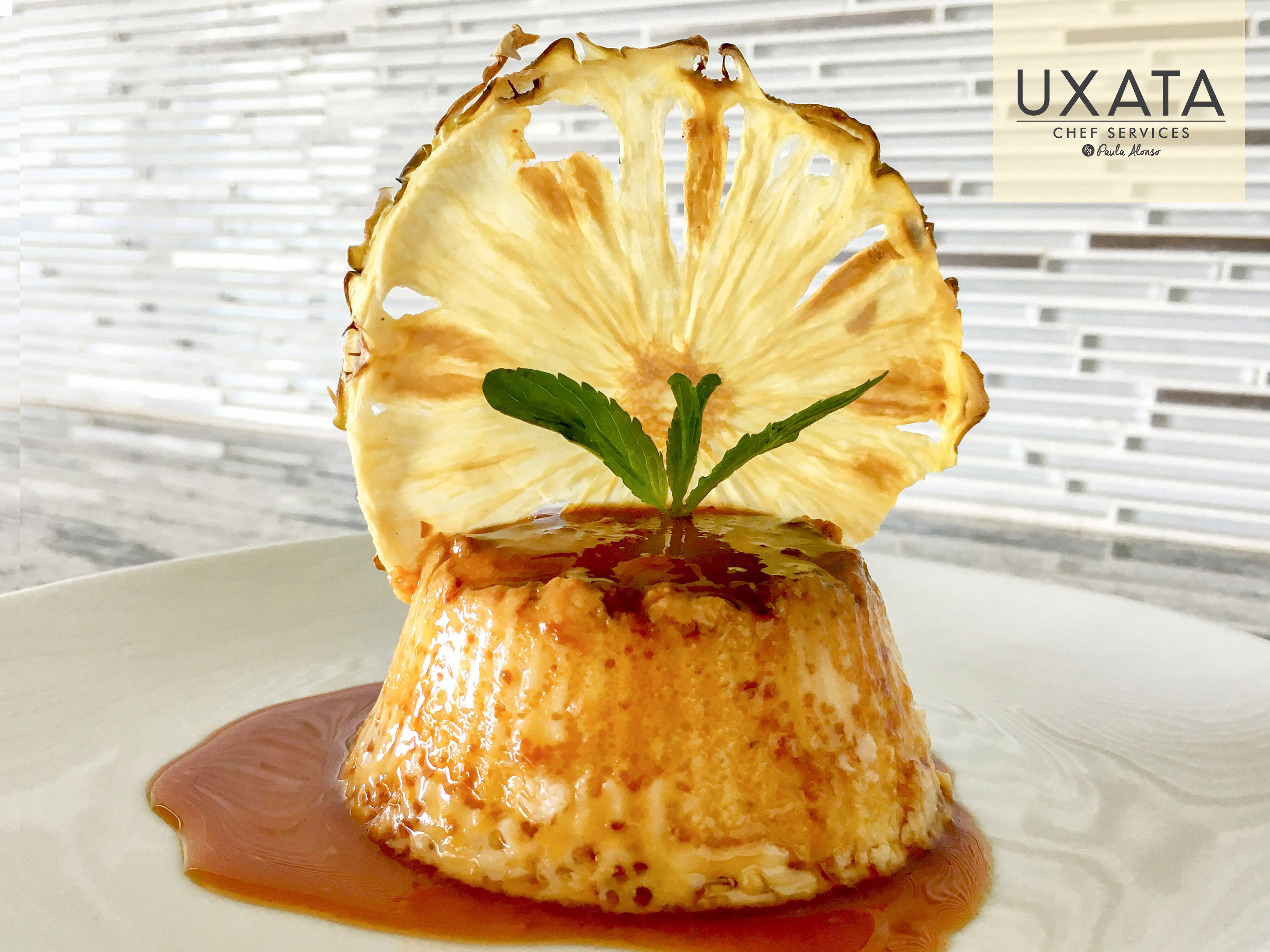 Presentation of individual caramel custard with decoration of caramelized sugar and mint leaves, by UXATA Private Chef Services, Playa del Carmen.
