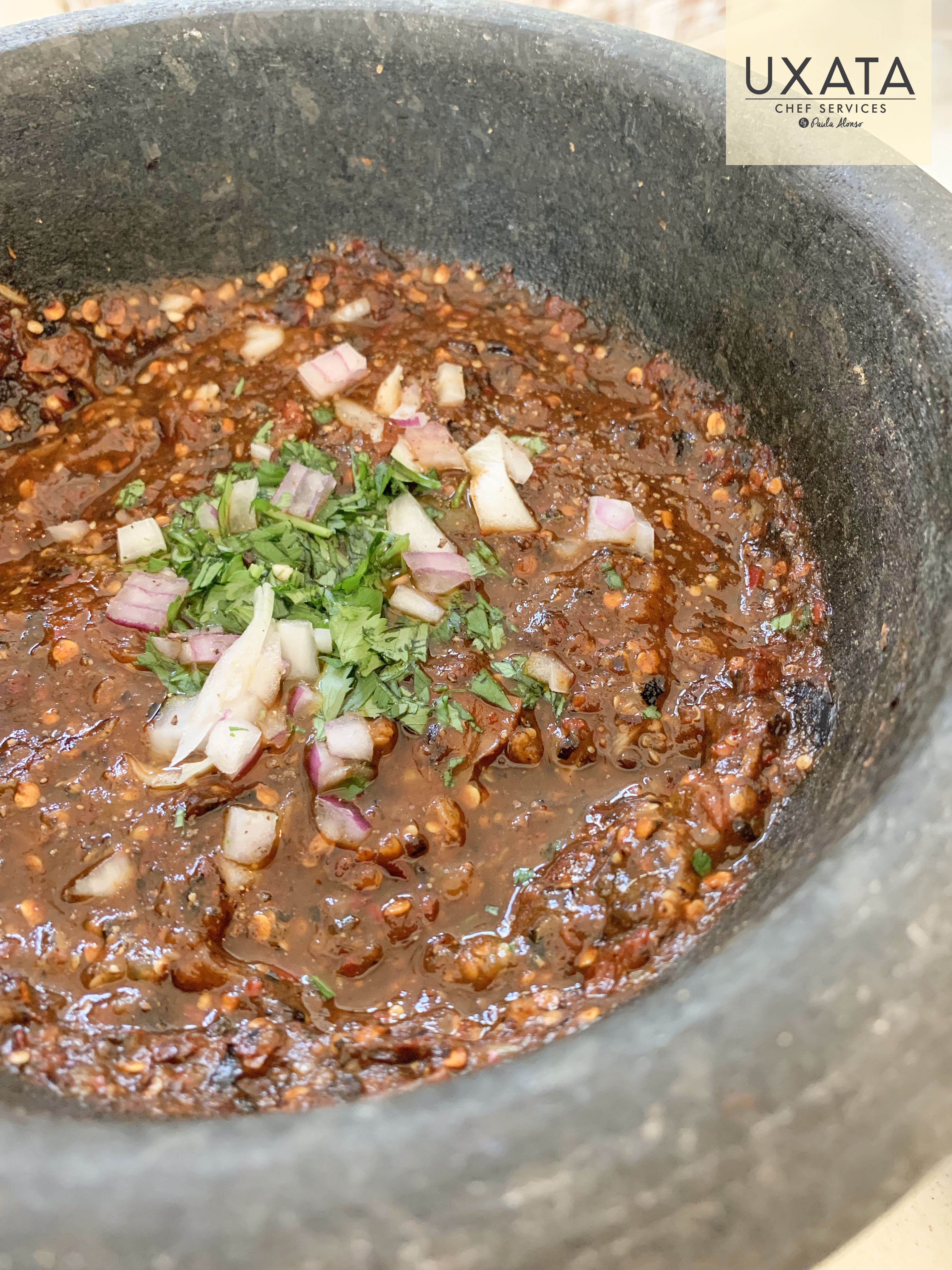 Guajillo, peanuts and seeds sauce in a molcajete, by UXATA Private Chef Services, Riviera Maya.